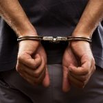 Close-up. Arrested man handcuffed
